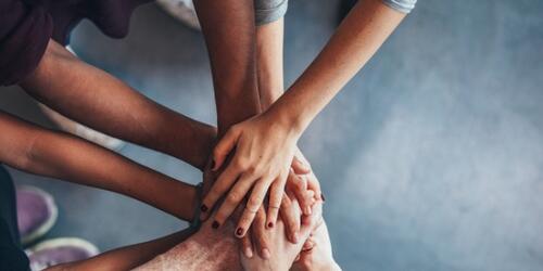 People holding hands in a circle